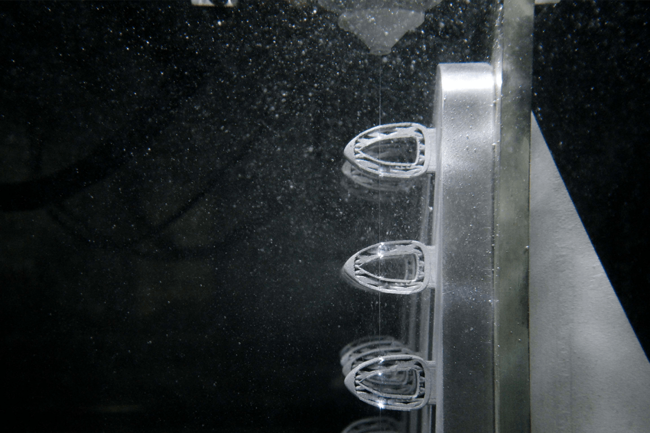 the inside of the FANUC RoboCut C600iC Wire EDM machine while in operation cutting a part